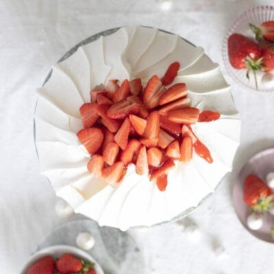 Pavlova cake with strawberries on a cake stand seen from above