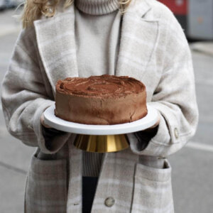 Truffle Cake held in hands on a stand