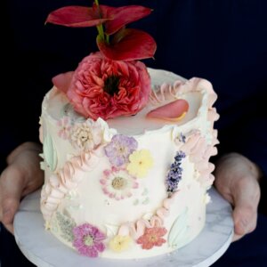 Birthday cake with colourful buttercream and flowers